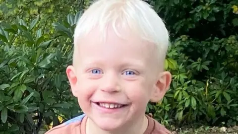 Family Handout Image of Oscar. He has blonde hair and is smiling.