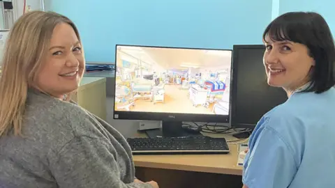 A mum and a neonatal sister watch one of the virtual tours on a computer