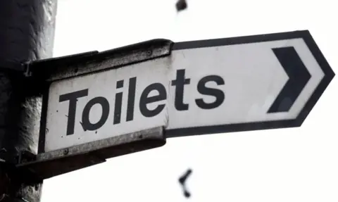 PA Media A white sign which says 'Toilets'