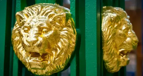 Lion's head onthe restored lighting columns at Queens Park Bridge, Heywood