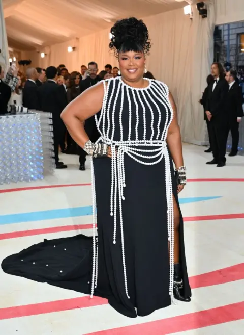 Getty Images Musician Lizzo dressed in pearls, like many others on Monday night