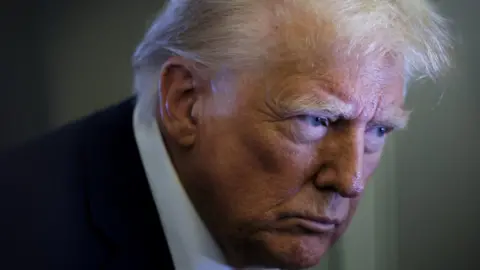 Heat phrases, for now, between Donald Trump and Sir Keir Starmer Reuters US President Donald Trump looks on as reporters ask questions aboard Air Force One during a flight from Las Vegas, Nevada, to Miami