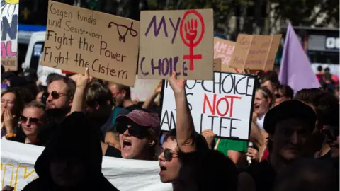 Getty Images Pro-abortion protesters wave placards in Cologne last September