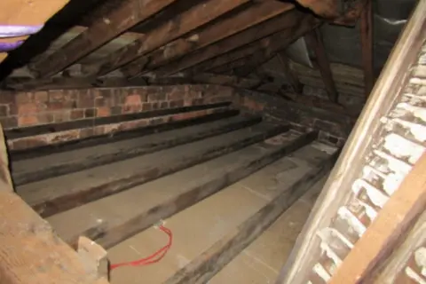 Derby City Council A photo of the loft space above the Market Hall shows beams and joists, some of which are reported to have been water-damaged.