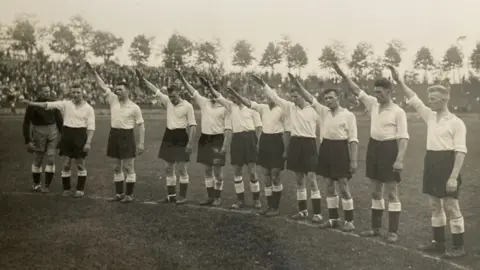 Paul Tattershaw A group of Derby County players performing a Nazi salute on a football pitch in Germany in 1934