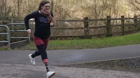 Family photo Claire Blackburn running with her prosthesis