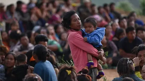 AFP People wait at a temporary shelter in a military camp, after being evacuated by the Indian army, as they flee ethnic violence that has hit the north-eastern Indian state of Manipur on May 7, 2023