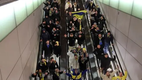 Reuters Maccabi fans descend an escalator in Amsterdam