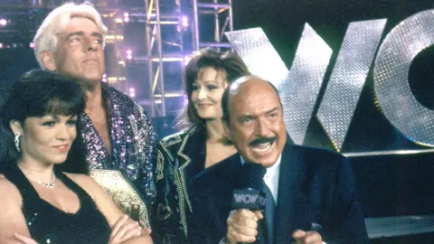 Getty Images Okerlund with Ric Flair, Miss Elizabeth and another unnamed woman