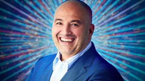 Wynne Evans, in a blue suit jacket