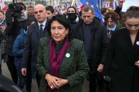 Georgia's President Salome Zourabichvili taking part in a pro-EU rally surrounded by dozens of people