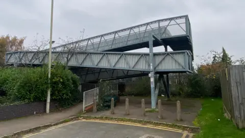 Blue and gray metal railway bridge. 