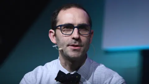 Getty Images Emmett Shear speaks at an event in Lisbon in 2018.