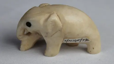 Bristol City Council/PA Wire An elephant ornament in carved ivory with inlaid ebony eyes and a small label on its body saying 'T/NIGE/732.