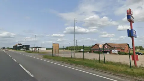 Google An area of the A1 which shows a dual carriageway with a car park next to it, and a building which says 'ok diner'.