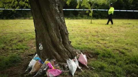 Getty Images Flowers around a tree