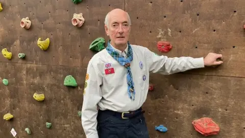 Guy Thompson Guy Thompson by a climbing wall