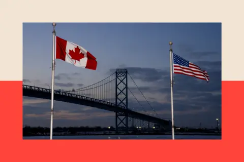 Getty Images Canadian and American flags near the Ambassador Bridge in Windsor, Ontario, Canada
