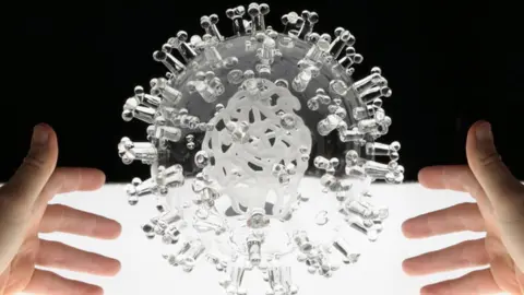 Luke Jerram A clear glass sculpture of the Covid-19 virus