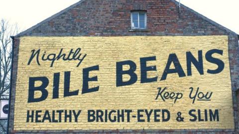 The Bile Beans sign in York includes the words Nightley Bile Beans Keep You Healthy, Bright-eyed and Slim on a yellow background