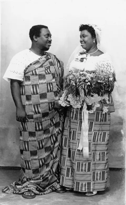 Deo Gratias Wedding couple in kente cloth