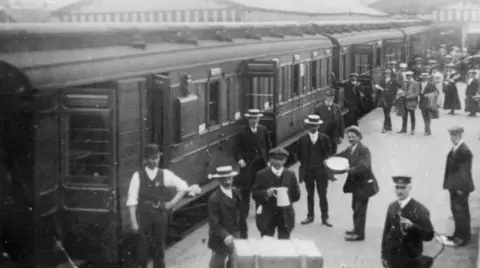 Somerset & Dorset Railway Trust An old black and white photo showing passengers using the Somerset and Dorset railway line