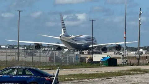 The plane sat on a runway in Palm Beach