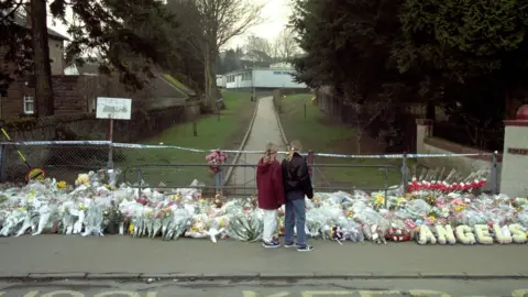 PA/Stefan Rousseau Floral tributes outside Dunblane Primary School