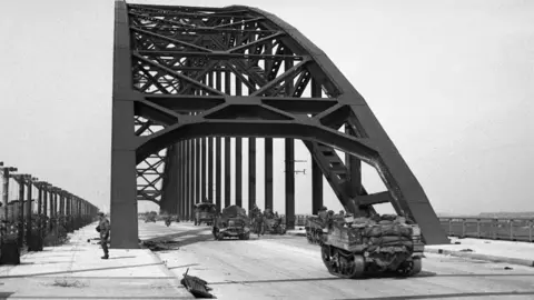 IWM/Getty Images Carriers and lorries crossing the bridge at Nijmegen, 21 September 1944
