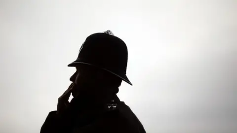 PA Media Silhouette of policeman