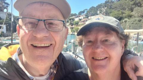 Alan and Karen Johnson on holiday. An older couple smiles at the camera