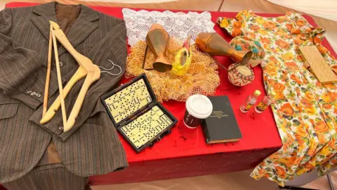 Clothes items that belonged to people from the Windrush generation who settled in the area.