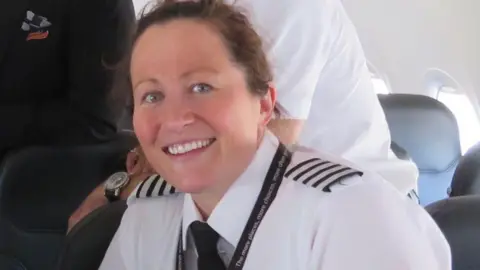 easyJet  Kate Newton smiling while wearing her pilot uniform on plane.