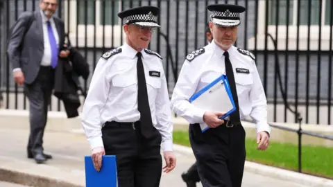 PA Media Metropolitan Police Commissioner Sir Mark Rowley (left) and Metropolitan Police Deputy Commissioner Matt Jukes leaving No 10 Downing Street.