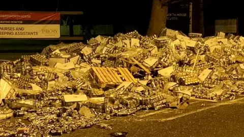 Crates and cans of beers on road