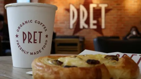 Reuters A coffee and a pastry are seen on a table inside a Pret A Manger store.