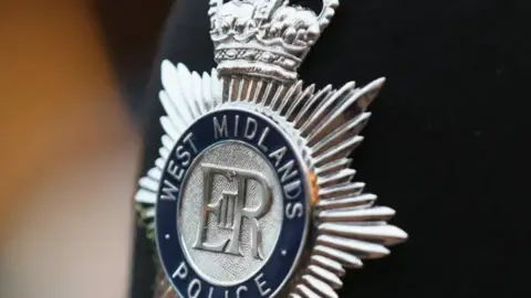 Getty Images A silver badge saying West Midlands Police