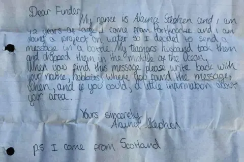  'Dear finder. My name is Alaina Stephen and I am 12 years of age. I come from Portknockie and I am doing a project on water so I decided to send a message in a bottle. My teacher's husband took them and dropped them in the middle of the ocean. When you find this message, please write back with your name, hobbies, where you found the message, when, and if you could, a little information about your area. Yours sincerely, Alaina Stephen. PS I come from Scotland.'
