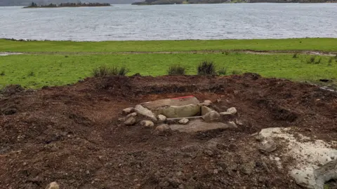 PA Media A burial site, near the sea