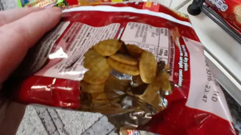 A close-up image of a broken packet of crisps showing its contents after it was gnawed away by mice