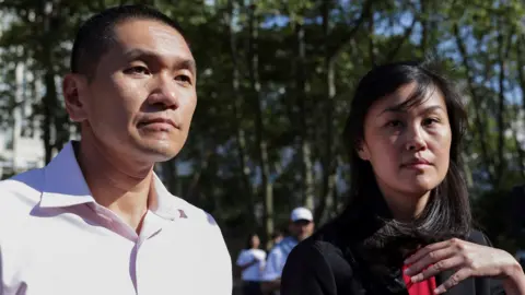 Reuters Linda Sun and Christopher Hu leave court