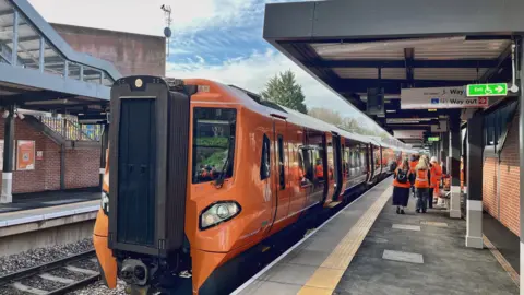 An orange train at a new railway station which is yet to open to the public