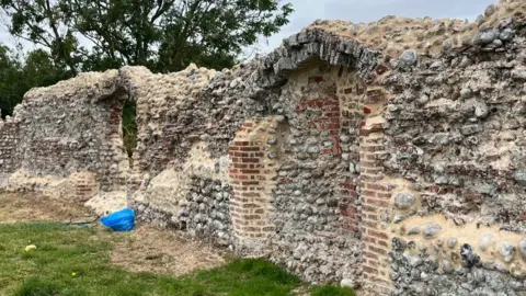 Andrew Turner/BBC Flint walls with brickwork repointed with new mortar to protect the structure from further decay