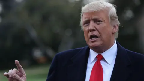  President Donald Trump in a suit and a red tie