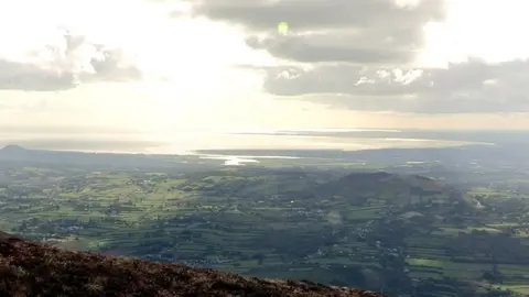 BBC The view of the surrounding countryside and Carlingford Lough from the top of Slieve Gullion