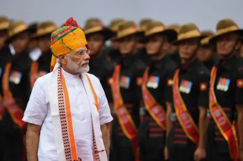 Getty Images India's Prime Minister Narendra Modi reviews a guard of honour during a ceremony to celebrate country's 73rd Independence Day, which marks the of the end of British colonial rule, at the Red Fort in New Delhi on August 15, 2019.