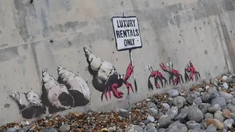 Laurent Forestier 'Luxury rentals only' mural, said to be by Banksy, at Cromer