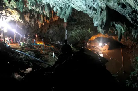 EPA Thai officials work to reduce the water level in a cave complex at the Tham Luang cave