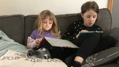 Family Photo Mollie and Nell doing their school work