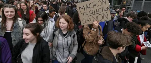 Getty Images A student holds a banner during a protest against a proposed reform of the Baccalaureat system in March 2018